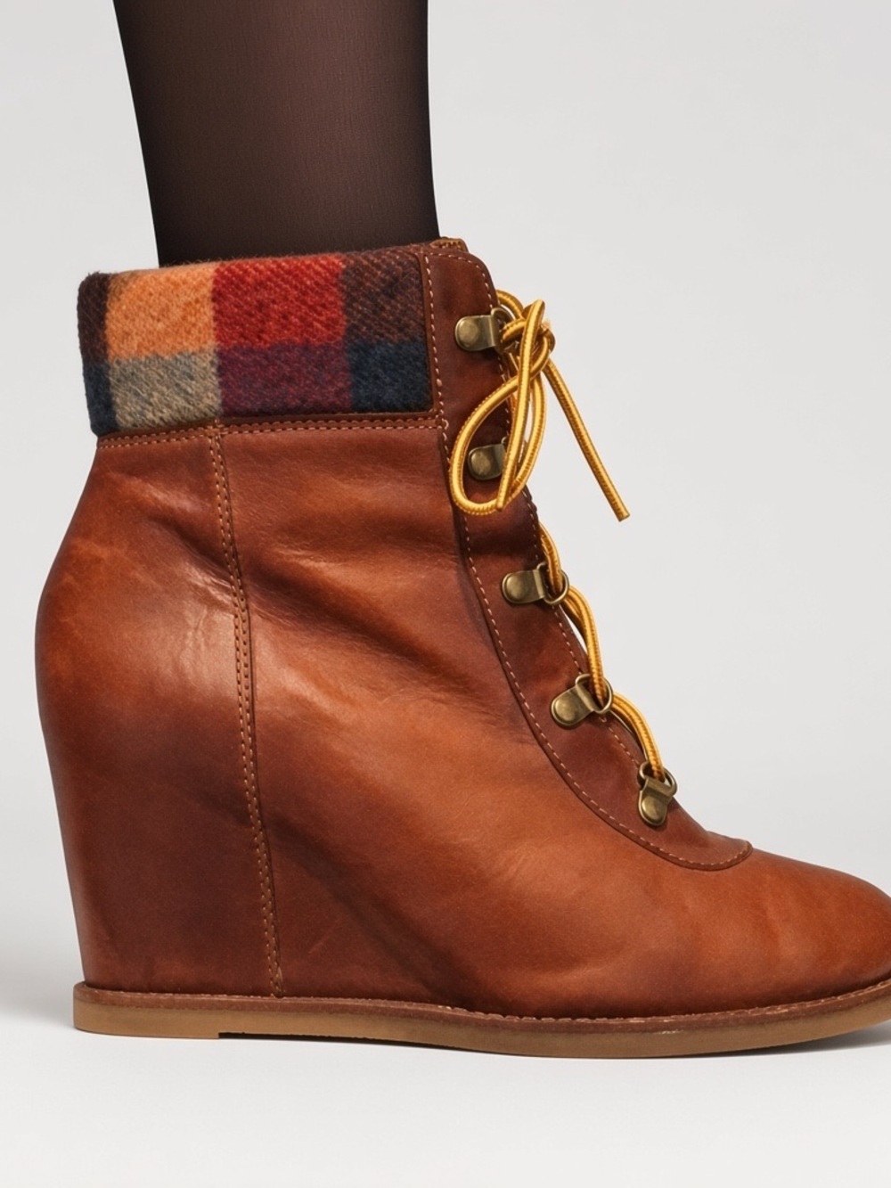 Soft leather brown lace up wedge booties.